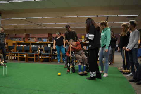 Beauty from Pain Albert, a visiting senior, has limited movement and brain function, yet enjoys a game of croquet with EHS students. The seniors were all wheeled around the "course". 
