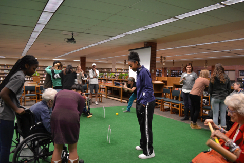 Through Hoops to Hope JiminyWicket, a Denver-based non-profit organization, teams up with Key Club and National English Honor Society (NEHS) at Eaglecrest to bond students and seniors over a game of croquet. Founder James Creasey is oversees the games under a white baseball cap. 