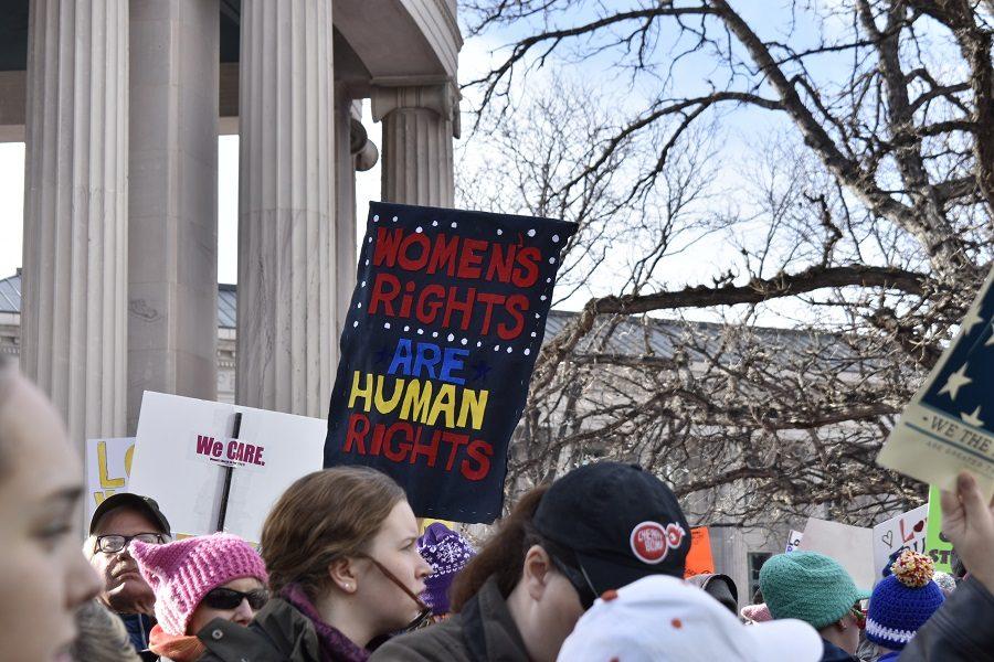 A demonstrator holds a sign reading, Womens Rights Are Human Rights, at the Denver Womens March.  The official Facebook page for the event, the march is meant to serve as a model of peaceful demonstration for young women and men, and girls and boys, who will be the leaders of tomorrow. 