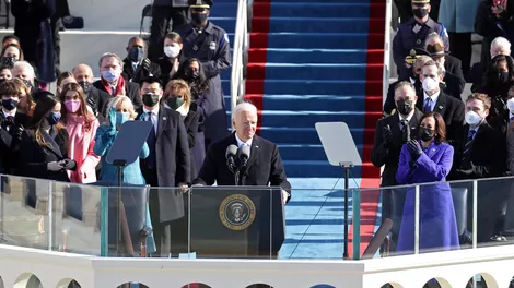 President Joe Biden during his Inaugural Address after being sworn in as 46th President of the United States, with members of the new administration and family members behind him. Image Courtesy of CNET.
