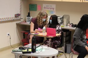 Lewis took a break from teaching for a moment to help her student figure out which number cards she needed. She flipped through each one, stating "do we need 14?", for example, and the student would reply with "no!"