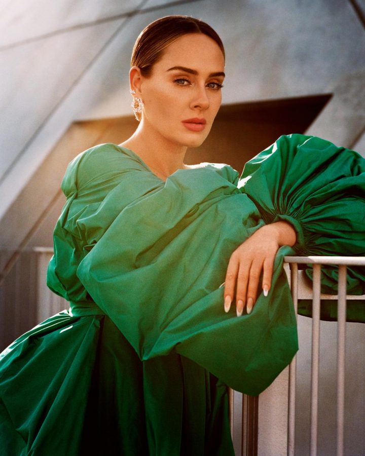 Caption: Back after a 6-year hiatus, Adele sports a green gown in a Vogue photoshoot.