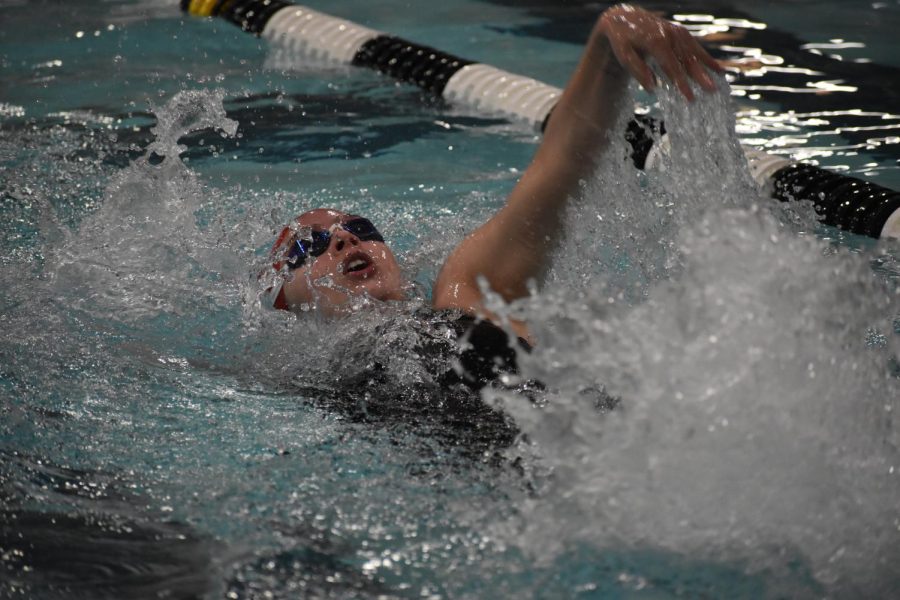 Lauren Menefee competes in a medley relay at Arapahoe High School, performing the backstroke.