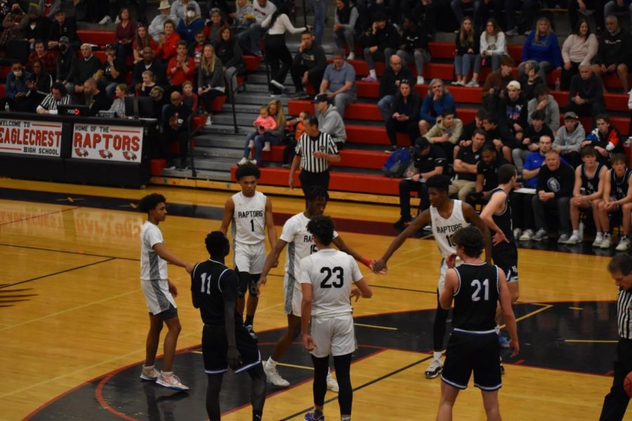 The team comes in to highfive Junior Joshua Ray as he gets ready for his second free throw attempt.