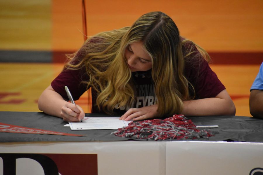 Volleyball commit Kylie Martin signs to University of Redlands at the April 13th signing ceremony.