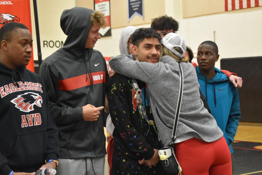 Teammate Ayden Shaws mother hugs volleyball commit Alfred Maiava immediately after the official signing.