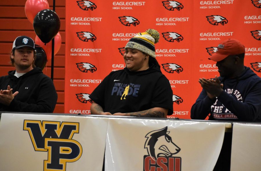 Amir Hall, a signee to William Penn University, smiles as his coach recounts the highlights of his high school football career.
