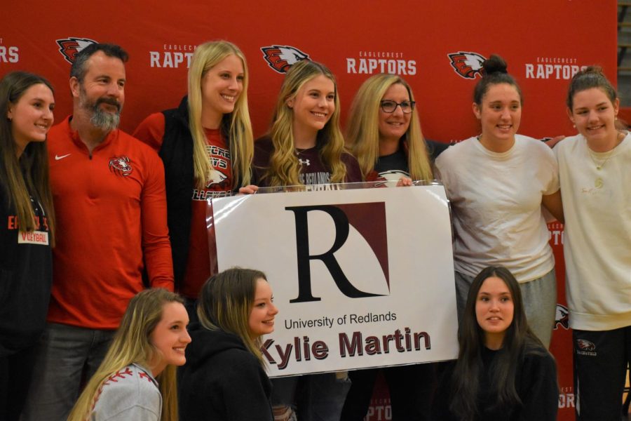 Teammates and coaches pose with signee Kylie Martin at the April 13th ceremony marking the culmination of her high school volleyball career.