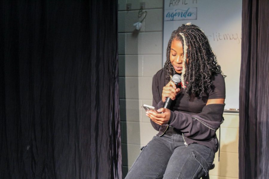 Funmi Oladipo reads to the audience during the open mic section of the night.