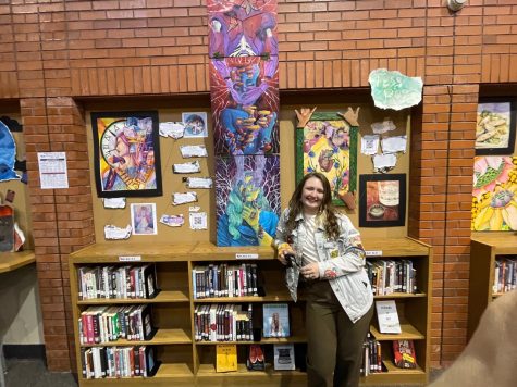 Tess Rosen poses with her art at the spring art show.