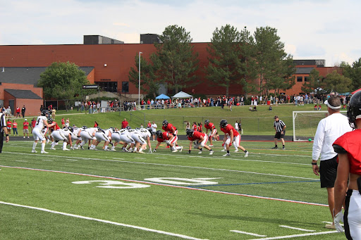 Football teams from Eaglecrest High School and Rock Canyon High School line up during a scrimmage.