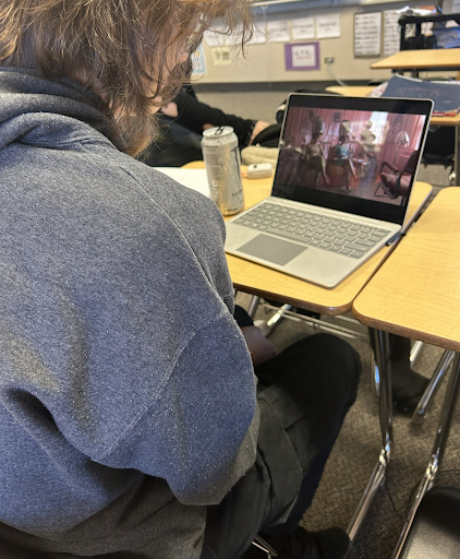 Junior Connie Runberg is enjoying his free time in class by watching the Priscilla movie. 