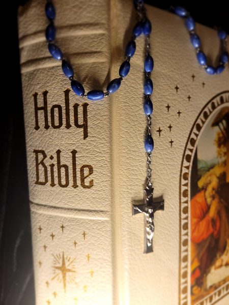 Two staples of Christianity: the Holy Bible, and the rosary.
