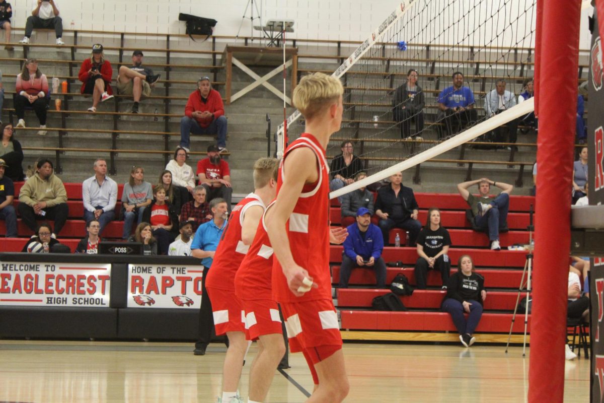 The front row of the EHS Boys Varsity Volleyball team watches Grandview High School serve the ball as they think about how they will execute the point.