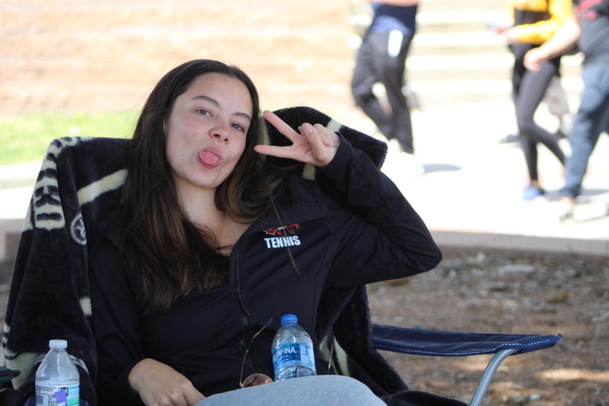 Senior Kate Stephens watches her teammates' matches at Cherry Creek High School during the girls tennis regional tournament.