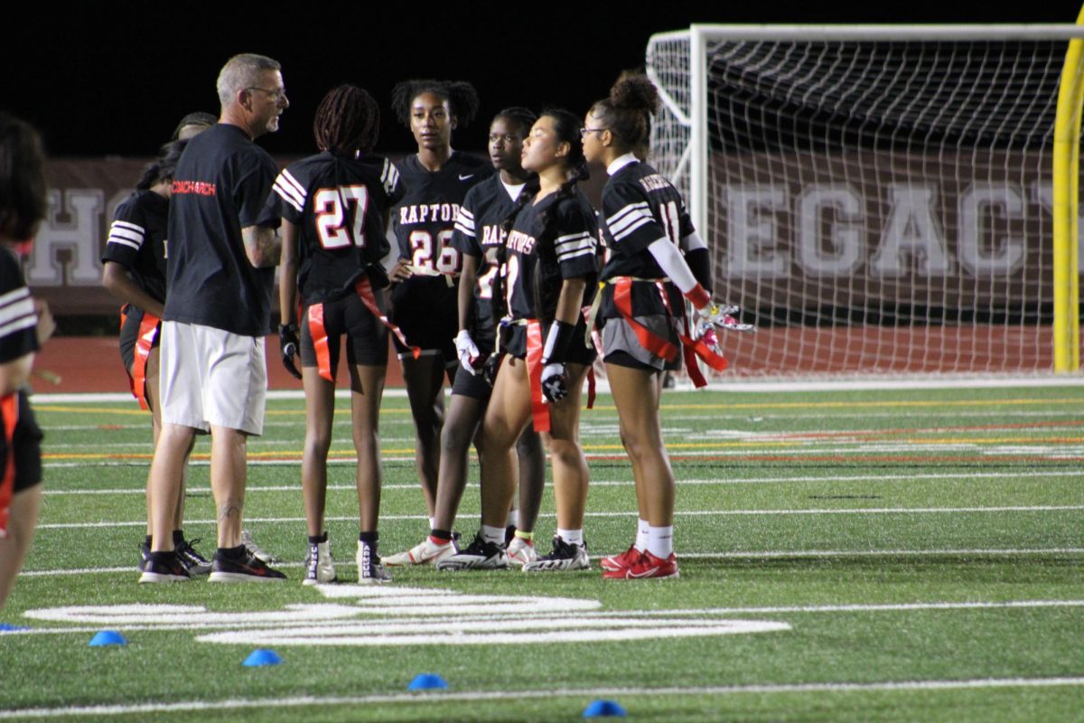 The defensive team huddling up to work out plays. Talking to Assistant Coach Jason Archuletta.