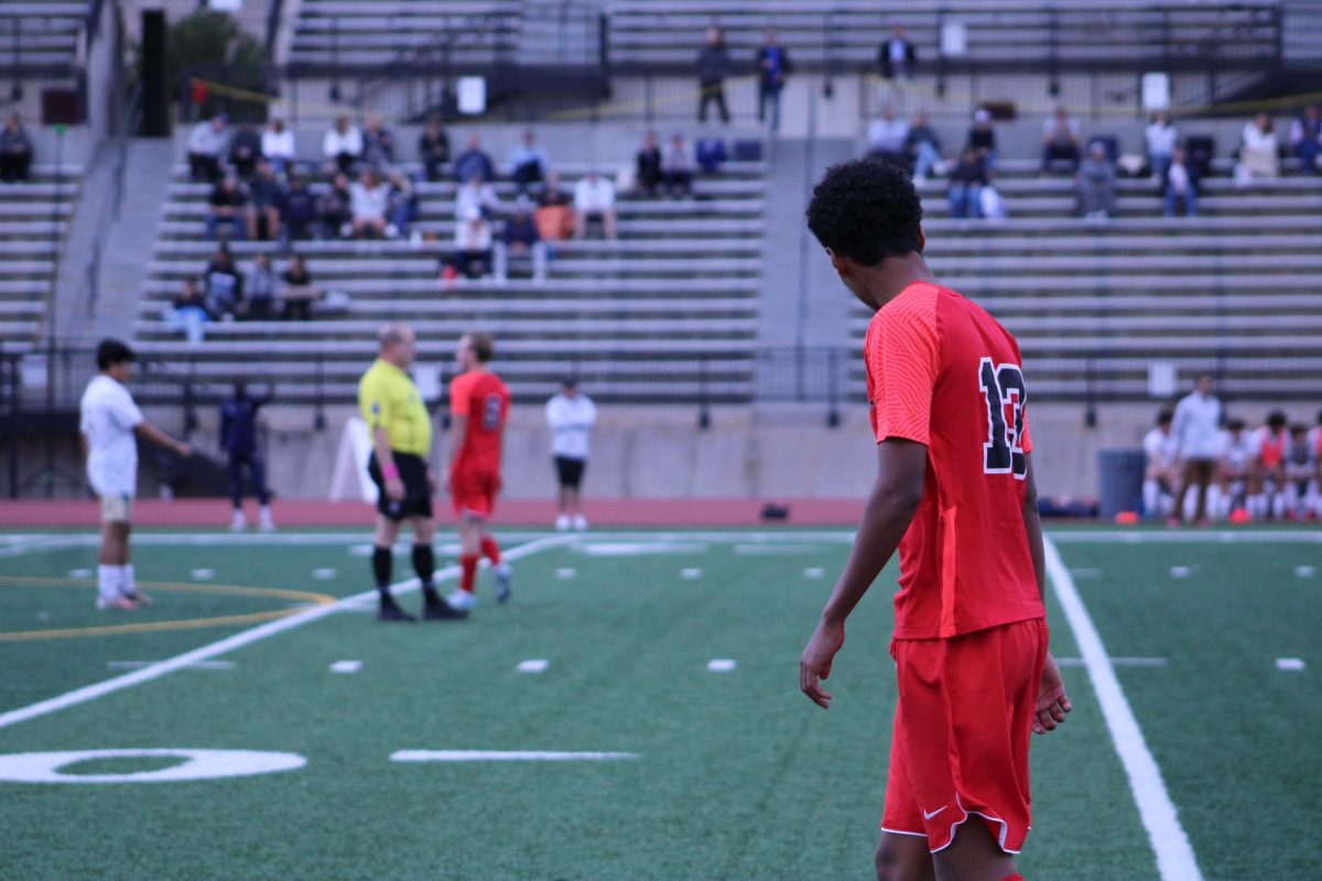 Junior Adam Keresemo walking along the edge of the field.