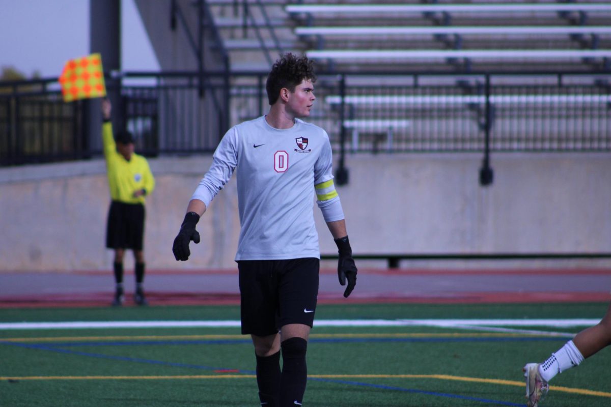 Senior Blair Nelson walking to the goal to support his team. 