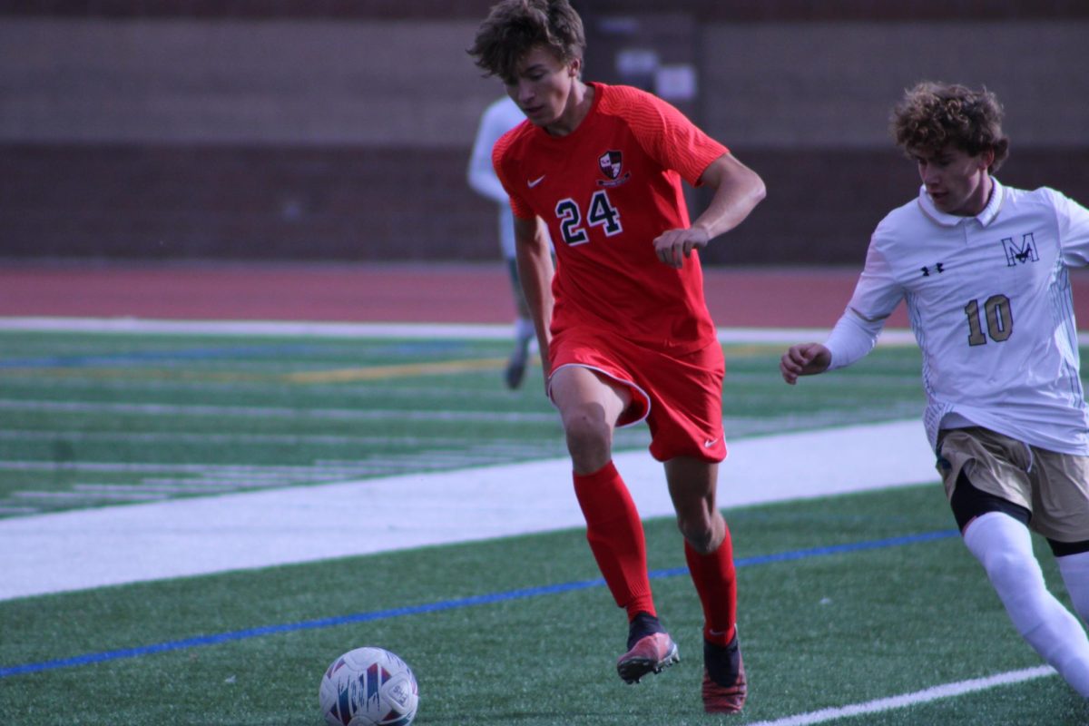 Senior Gus Zillman dribbling the ball down the field.