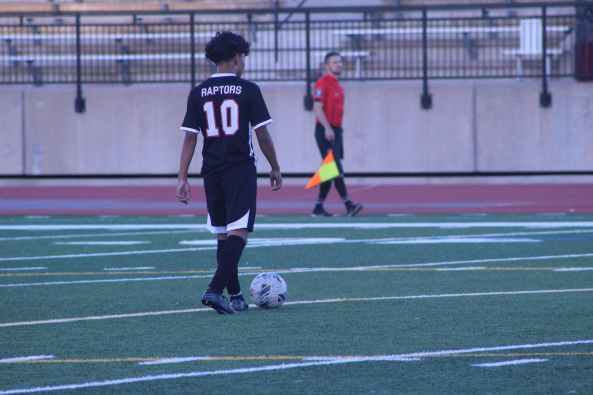 Junior Cris Ramirez moves the ball across the field and gets ready to get back into the heat of the game.