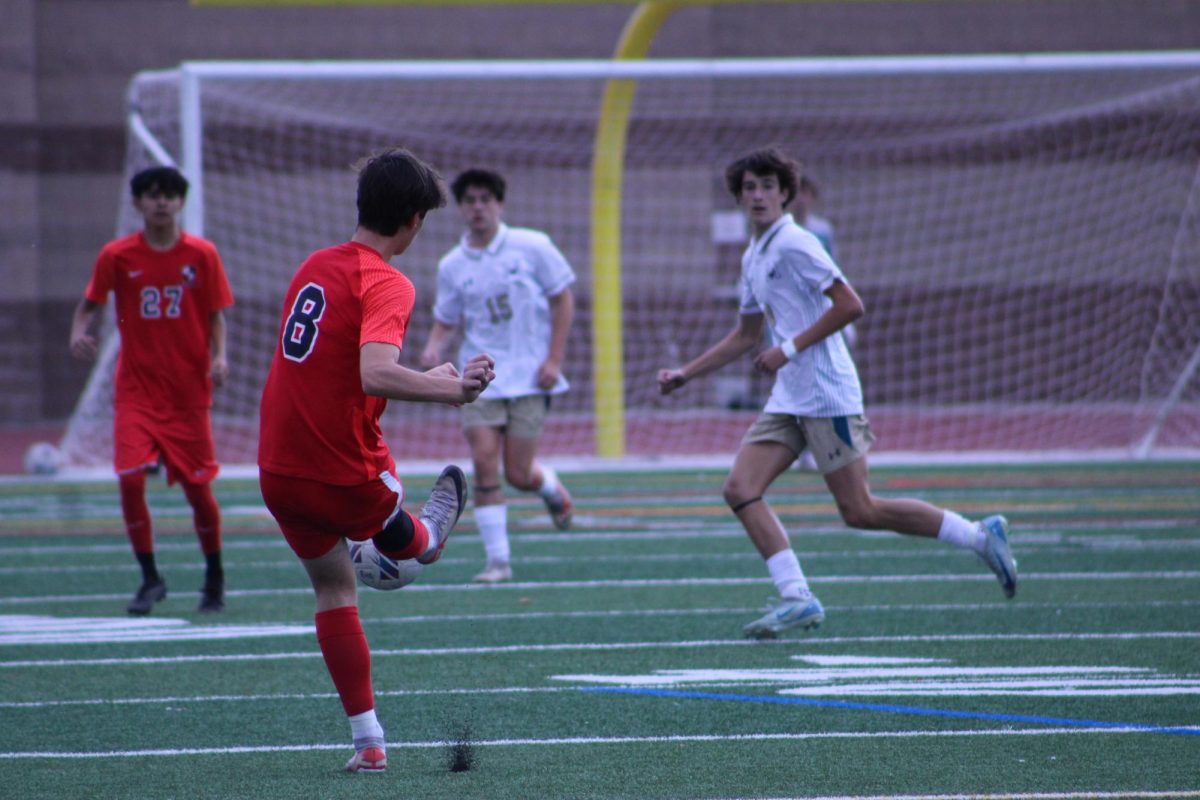 Senior Isaac Olszewski passing the ball to his teammate. 