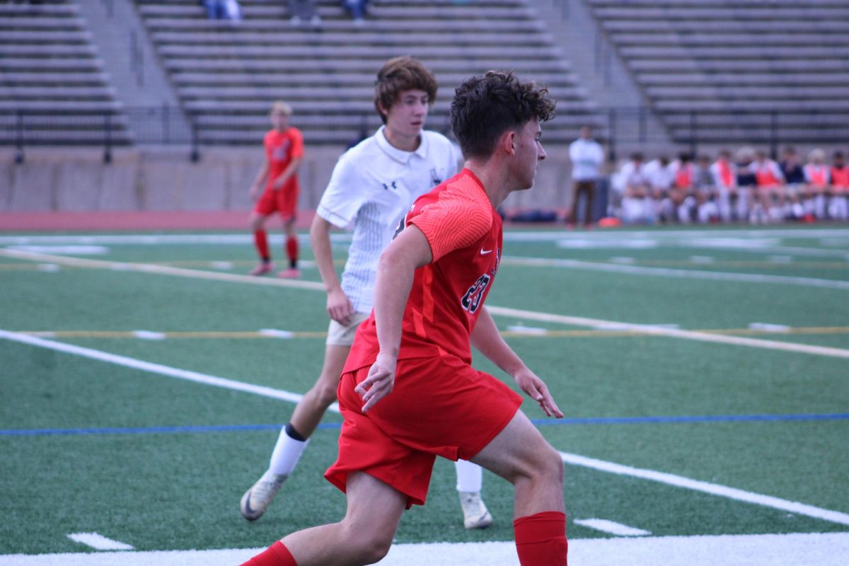 Junior Kyle Groves kicking the ball.