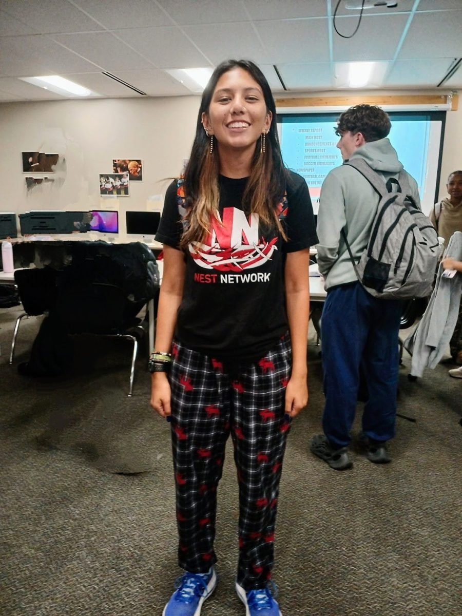 Skyla Mazotti, senior, shows off her pajama pants in the classroom.