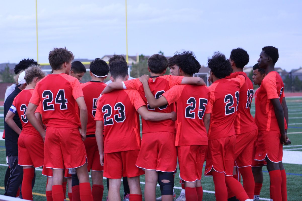 Eaglecrest soccer team in the huddle before the game starts.