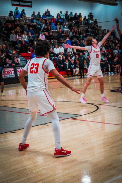 Senior La'quince York defending his guy while senior Garret Barger tries to block the shot. 