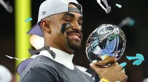 Eagles quarterback Jalen Hurts holding up the Lombardi trophy after winning the Super Bowl