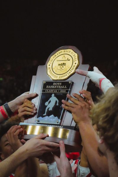 The Eaglecrest Raptors lift the trophy after winning the state championship.