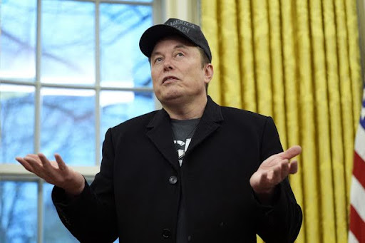 Elon Musk wearing a MAGA hat in an Oval Office appearance.