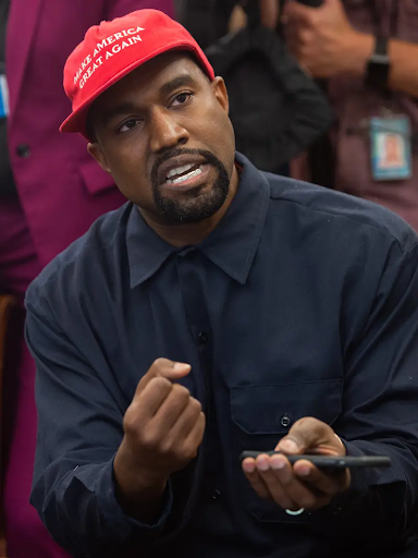 Kanye West pictured at an Oval Office meeting wearing a MAGA hat.