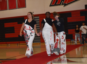 On each strap, bedazzlements and bandannas stylized Ella Keith, Nikkee Graham, and Izzy Munib's (left to right) overalls and pants as they giggle their way down to the end of the carpet.