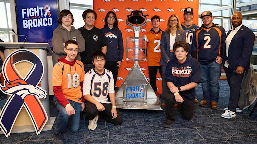 EHS and CCIC show off their newly crafted cancer bell along side member of the Broncos administration.